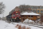 WAMX 4178 past the depot with an eastbound grain+sand train